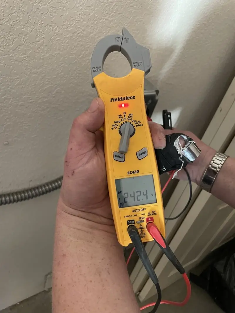 Voltage testing with clamp meter during Electrical Installation Services in Folkston
